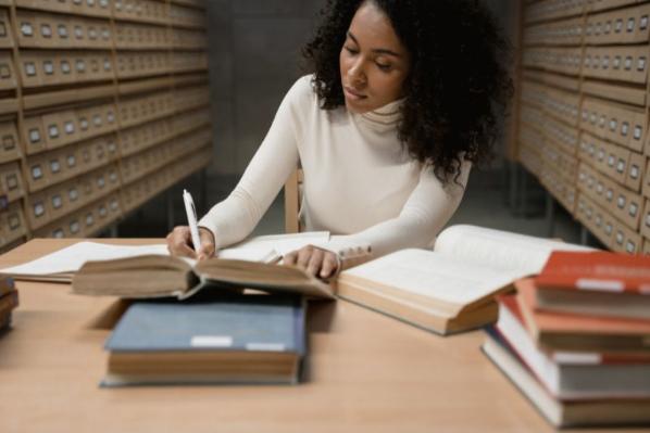 female student studying with books